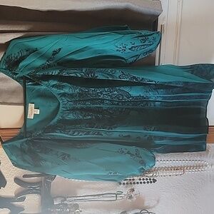 Turquoise and black floral blouse.